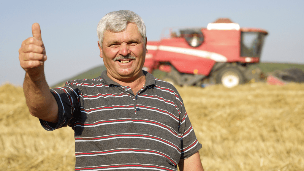 A happy farmer standing in his field