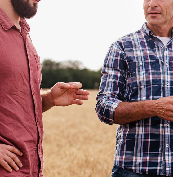 Financial expert explaining to farmer on field