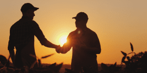 Farmer shaking hands with financial expert